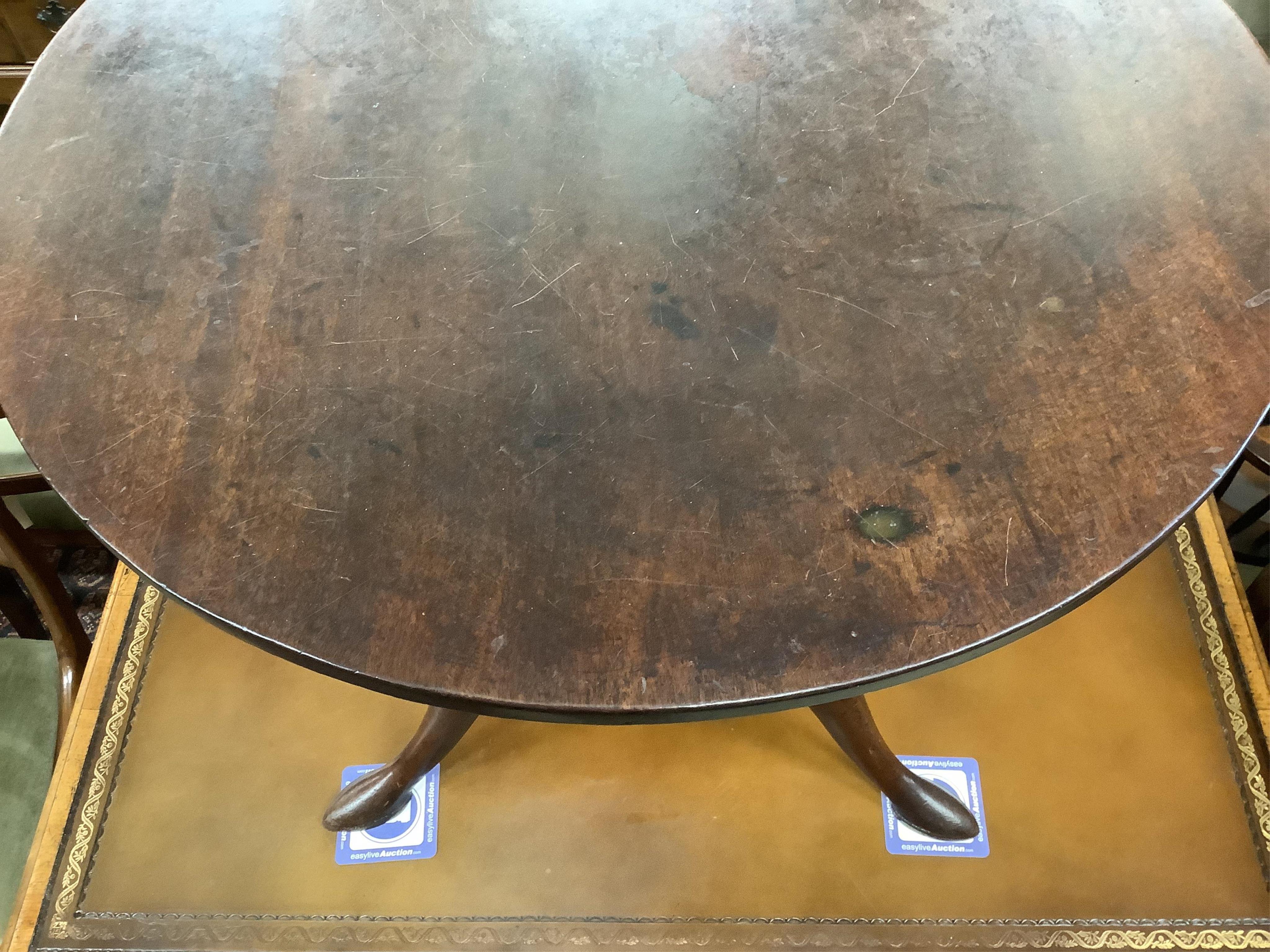 A George III circular mahogany tilt top bird cage tripod tea table, diameter 69cm, height 69cm. Condition - fair